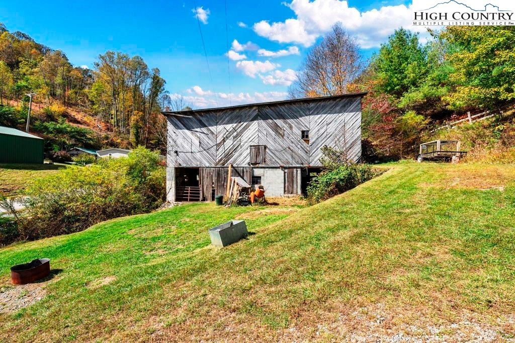 1068 Laurel Branch Road Vilas, NC 28692 - Photo 22 of 33 a view of a house with a big yard plants and large tree