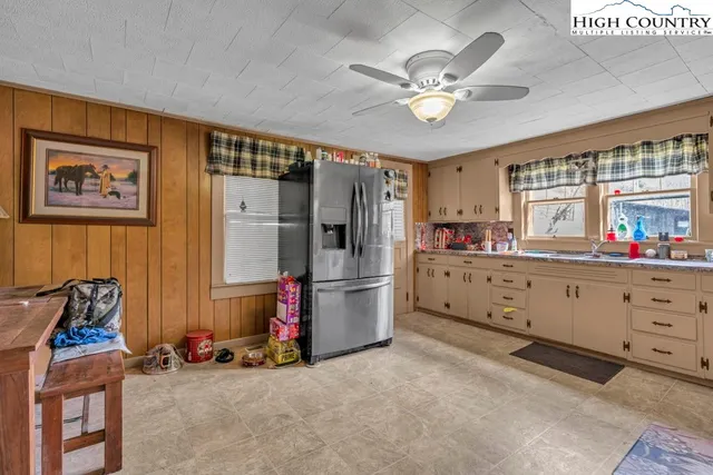 a large kitchen with a stove and wooden cabinets