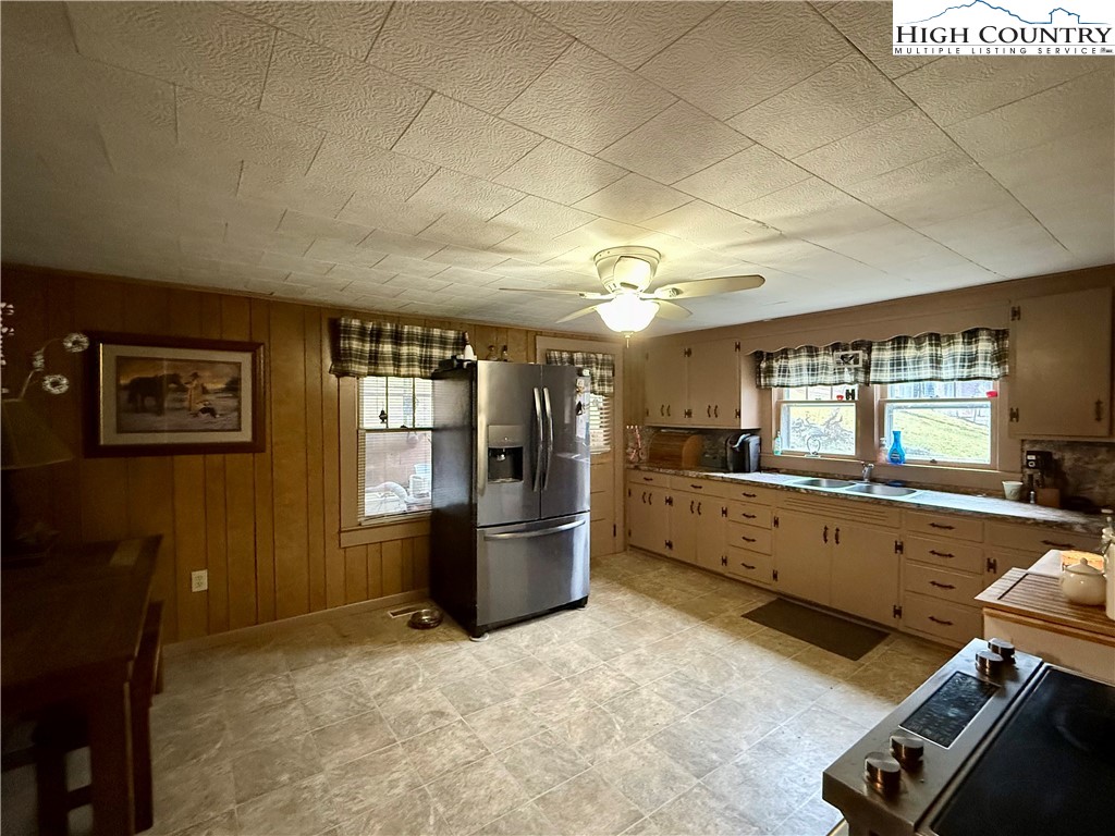 1068 Laurel Branch Road Vilas, NC 28692 - Photo 6 of 33 a large kitchen with a stove and wooden cabinets