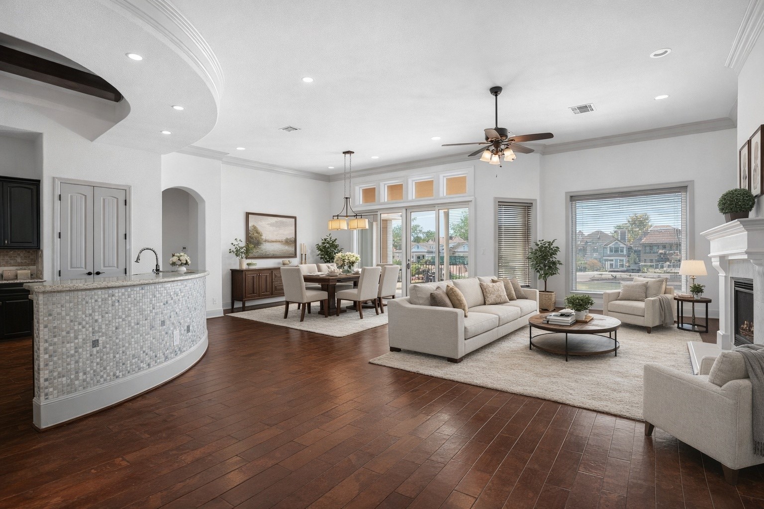 12349 Tramonto Conroe, TX 77304 - Photo 12 of 50 This spacious, open-concept living area features elegant hardwood floors, abundant natural light, and a seamless flow between the kitchen, dining, and living spaces. The kitchen boasts a stylish curved bar, while large windows and a cozy fireplace enhance the inviting atmosphere.