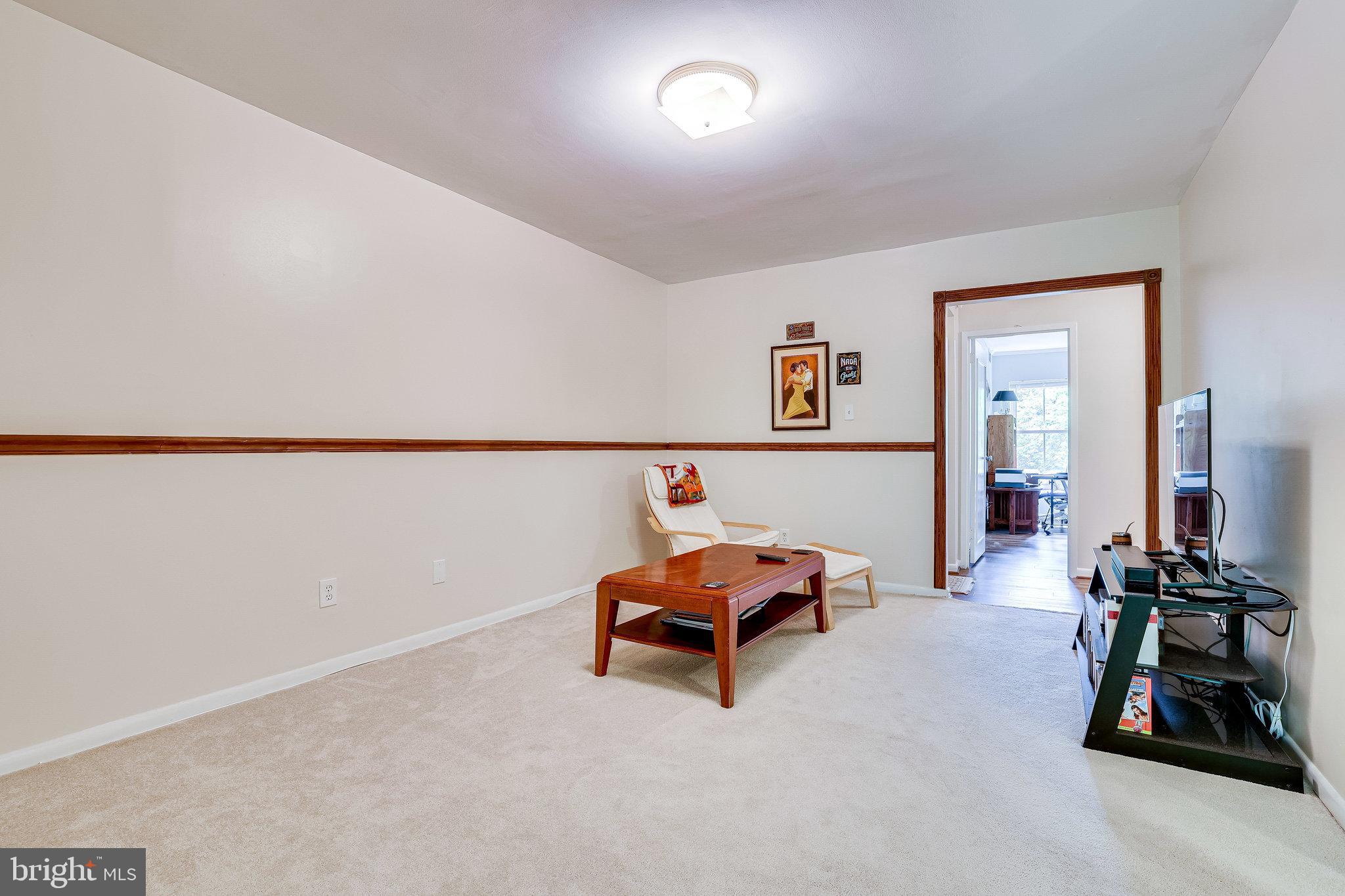 11621 Stoneview Square, Unit 22C Reston, VA 20191 - Photo 7 of 37 Living Room with Chair Railing