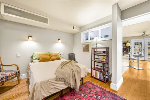 a bedroom with a bed and a book shelf