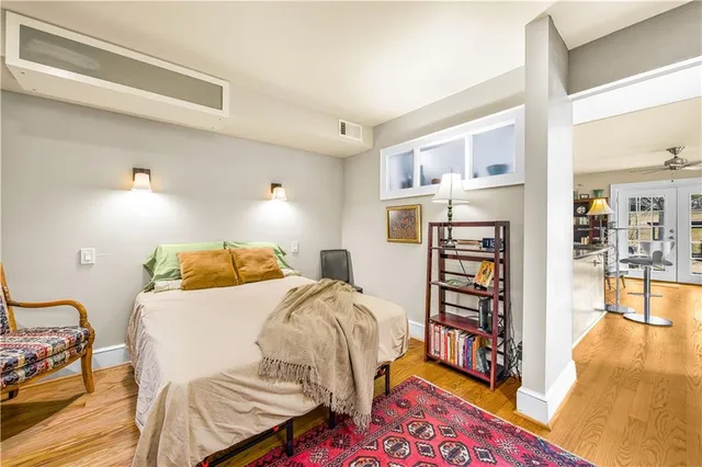 a bedroom with a bed and a book shelf