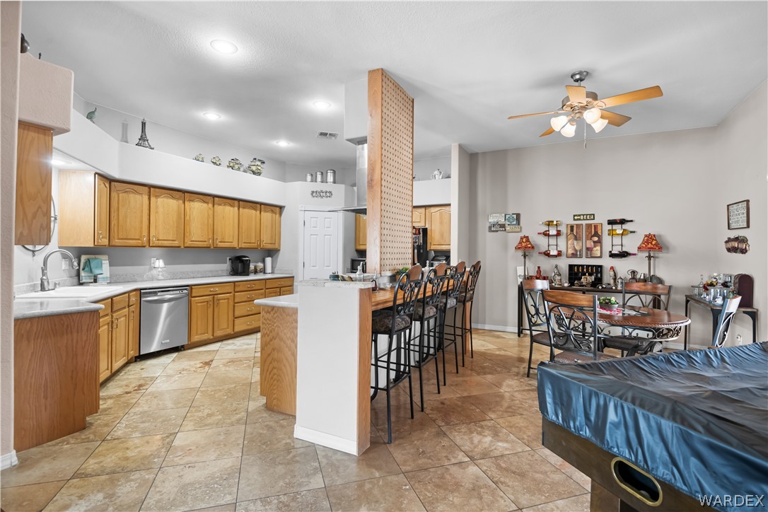 2898 Mountain Trail Road Kingman, AZ 86401 - Photo 8 of 75 a kitchen with stainless steel appliances lots of wooden furniture