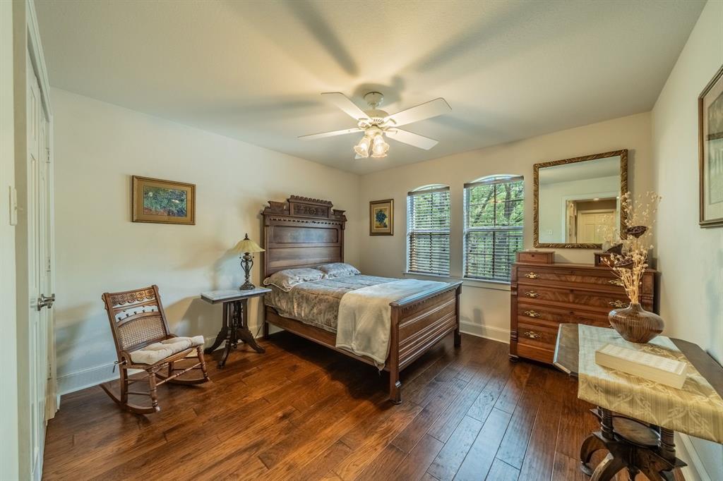 7451 County Road 1509 Athens, TX 75751 - Photo 16 of 36 a bedroom with a bed and wooden floor