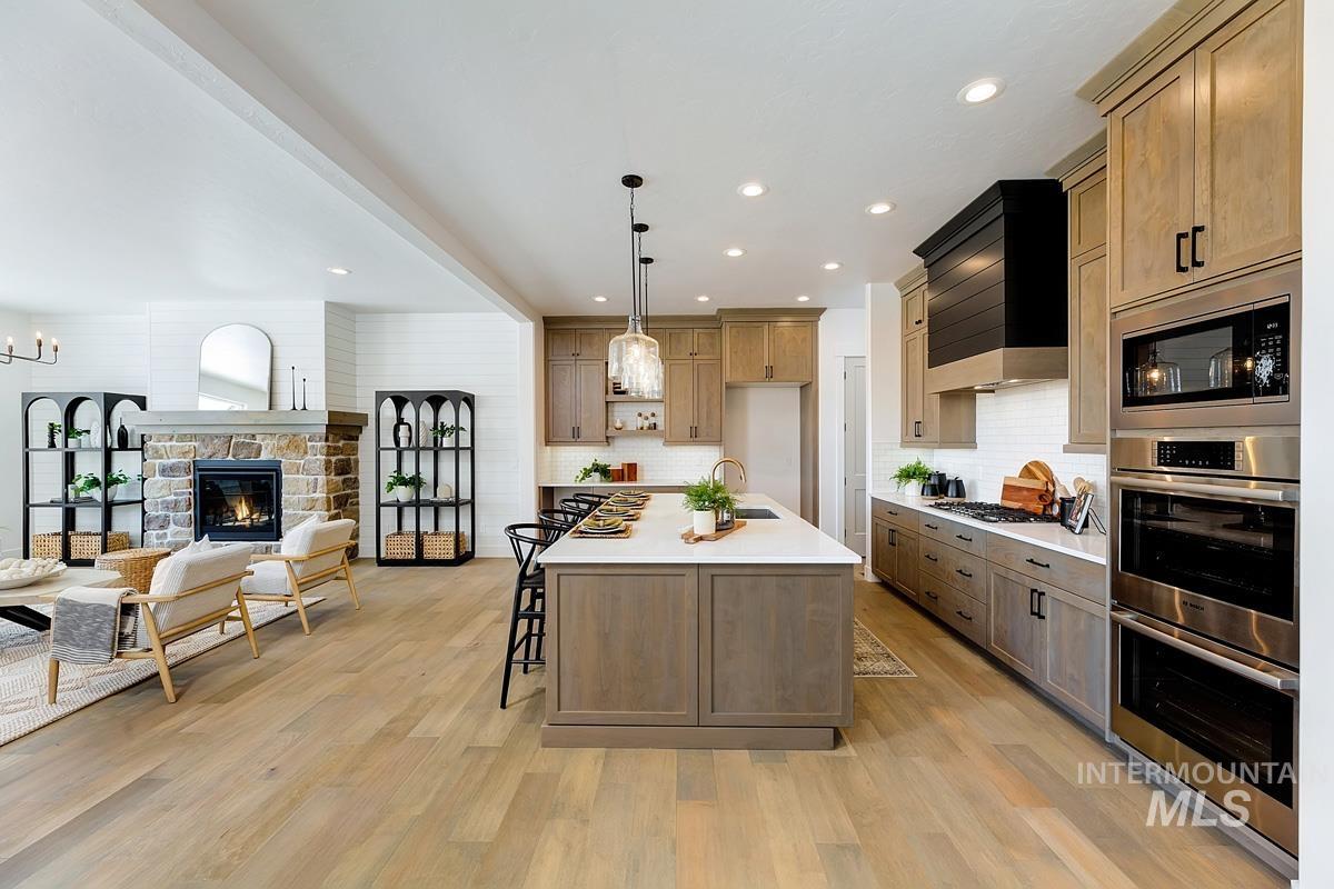 21913 Paint Avenue Star, ID 83669 - Photo 44 of 45 Kitchen featuring hanging light fixtures, open floor plan, stainless steel appliances, an island with sink, and a breakfast bar