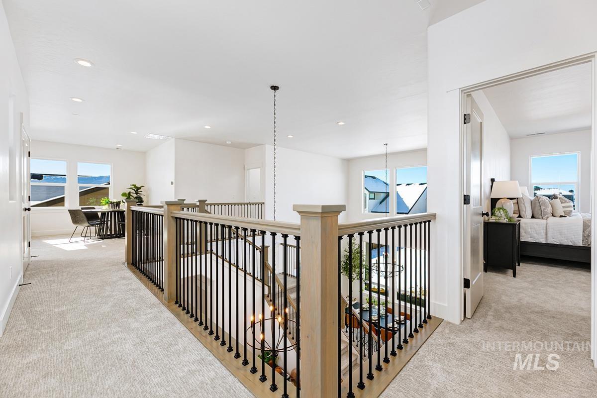 21913 Paint Avenue Star, ID 83669 - Photo 22 of 45 Corridor featuring light carpet, an upstairs landing, recessed lighting, and a chandelier