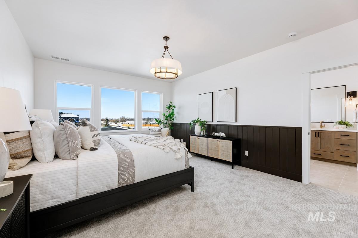 21913 Paint Avenue Star, ID 83669 - Photo 25 of 45 Bedroom with wainscoting, light colored carpet, wood walls, and connected bathroom