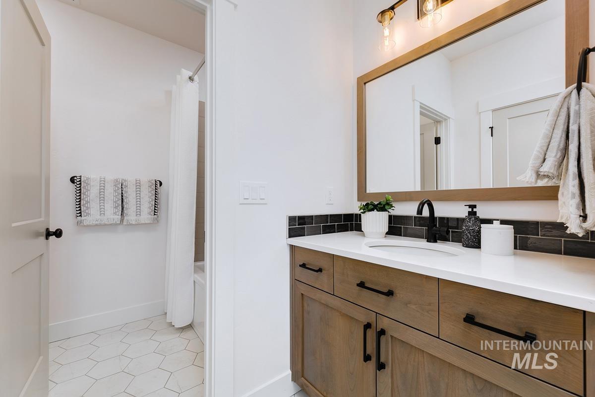 21913 Paint Avenue Star, ID 83669 - Photo 30 of 45 Bathroom featuring vanity, light tile patterned floors, and shower / bath combo