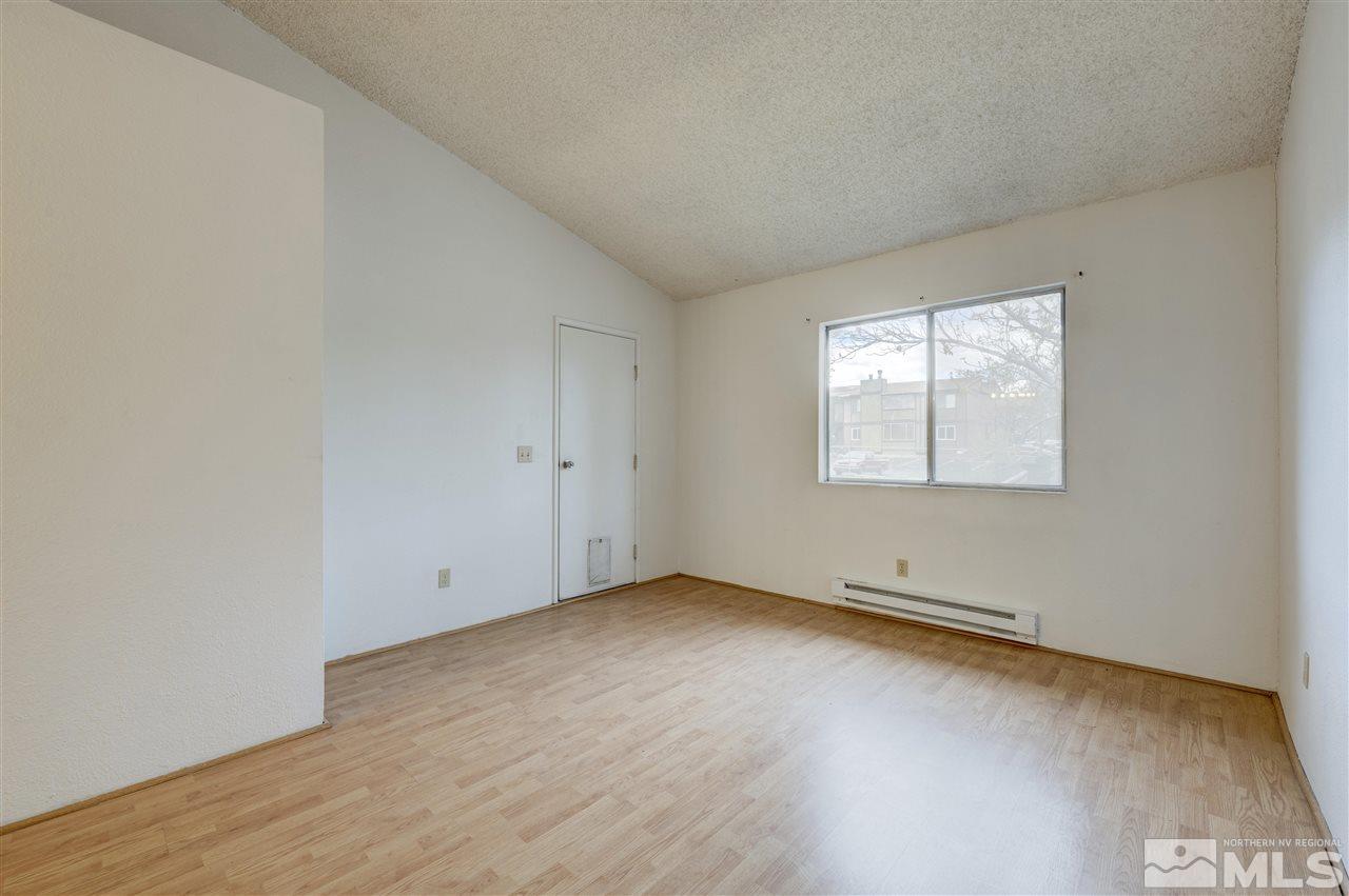 2101 Highview Court, Unit 14 Reno, NV 89512 - Photo 13 of 16 an empty room with wooden floor and windows