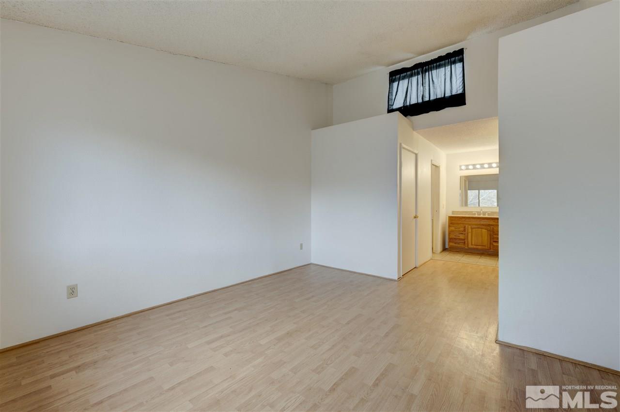 2101 Highview Court, Unit 14 Reno, NV 89512 - Photo 14 of 16 a view of a hallway with wooden floor and a living room