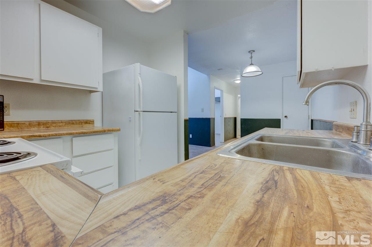 2101 Highview Court, Unit 14 Reno, NV 89512 - Photo 4 of 16 a kitchen with a sink cabinets and appliances