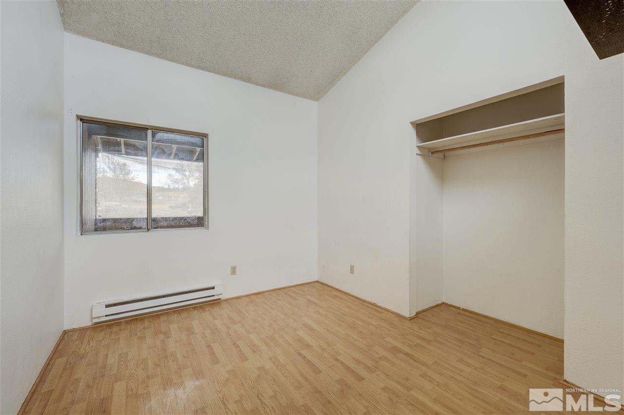 2101 Highview Court, Unit 14 Reno, NV 89512 - Photo 8 of 16 a view of an empty room with wooden floor and a window