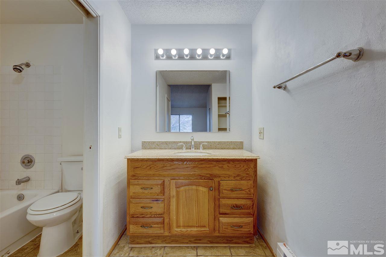 2101 Highview Court, Unit 14 Reno, NV 89512 - Photo 9 of 16 a bathroom with a sink a toilet and shower