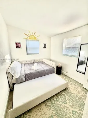 a living room with a couch and a rug