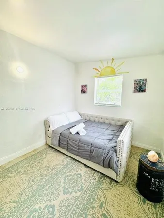 a bedroom with a bed and a couch