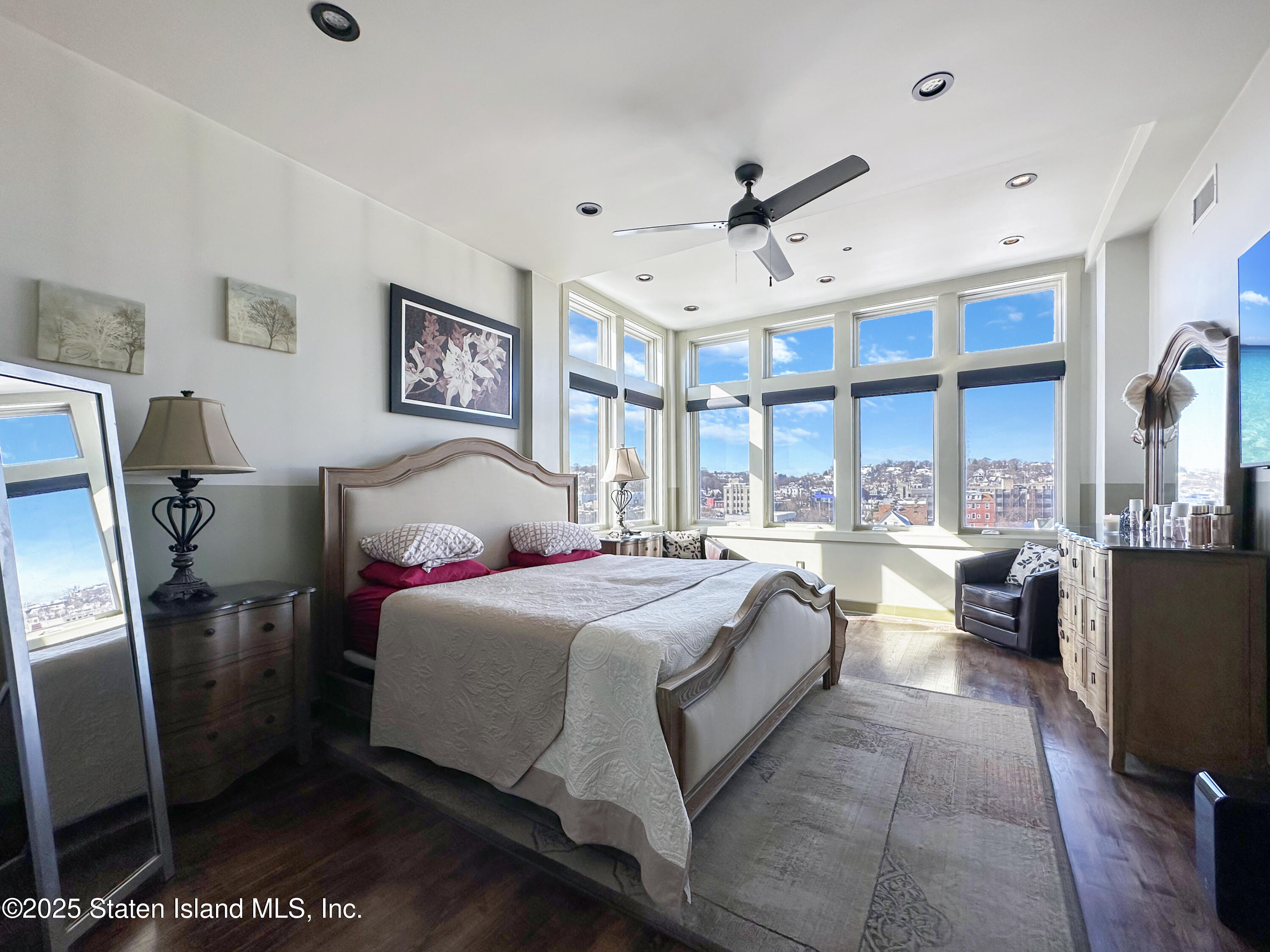90 Bay Street Landing, Unit 9C Staten Island, NY 10301 - Photo 12 of 38 a spacious bedroom with a bed and glass door