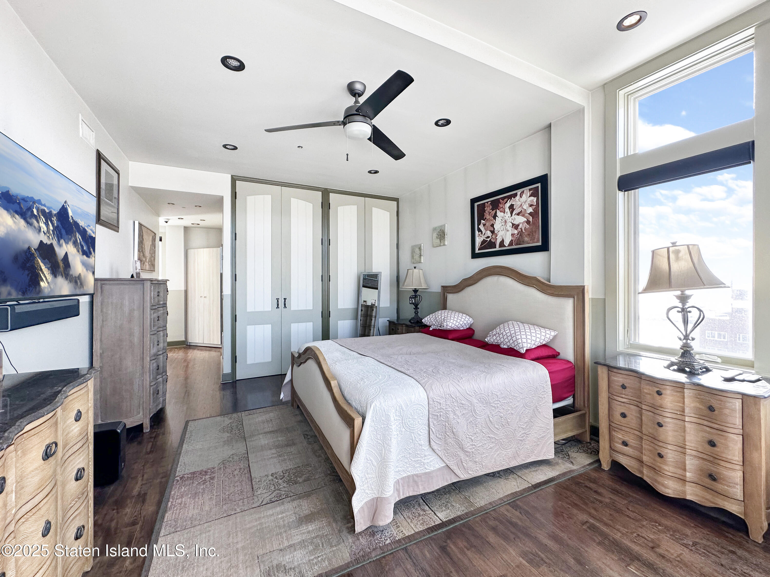 90 Bay Street Landing, Unit 9C Staten Island, NY 10301 - Photo 13 of 38 a bedroom with a large bed and a window