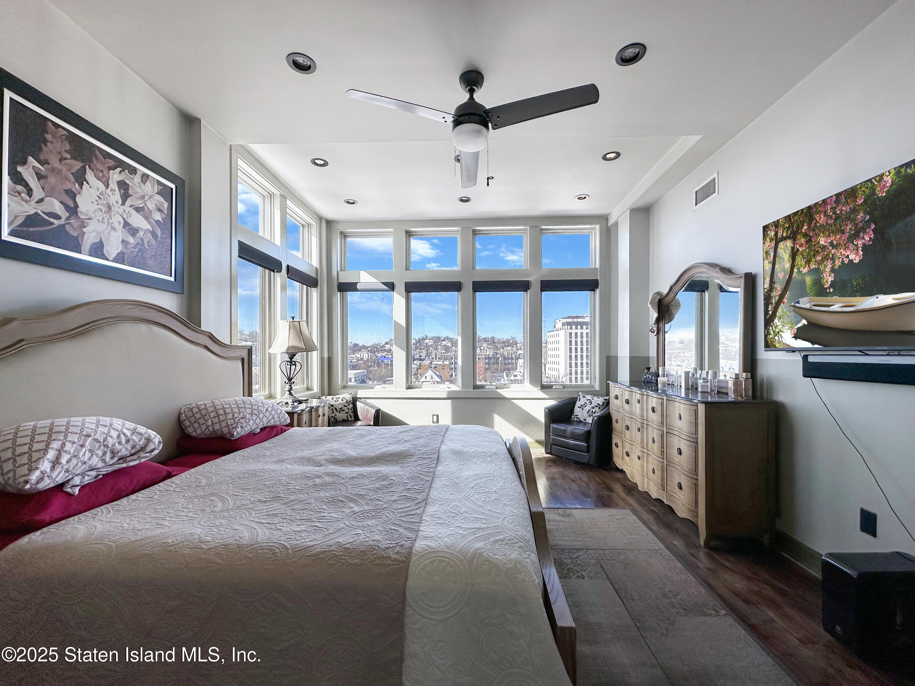 90 Bay Street Landing, Unit 9C Staten Island, NY 10301 - Photo 14 of 38 a spacious bedroom with a large bed and a large window