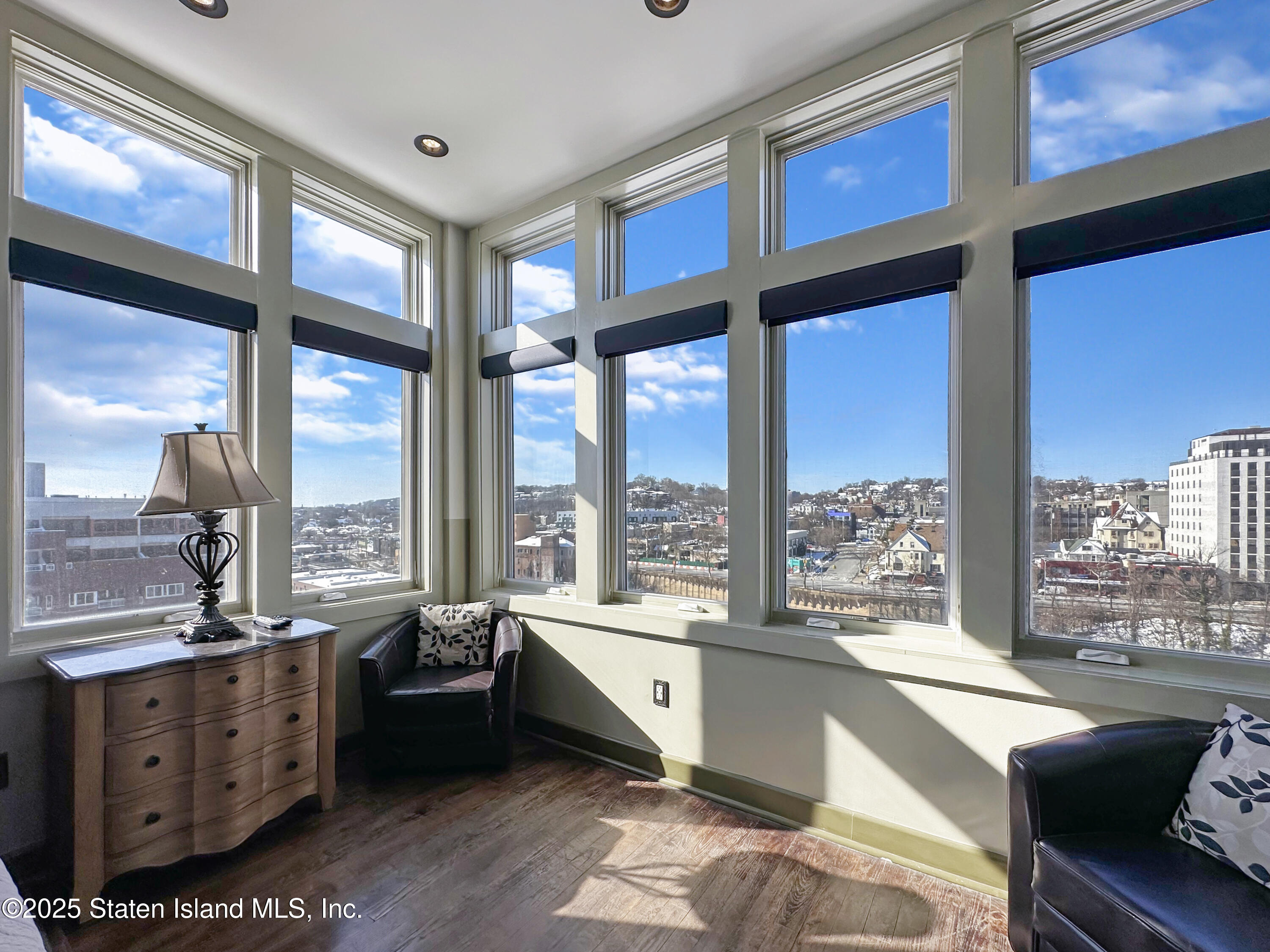 90 Bay Street Landing, Unit 9C Staten Island, NY 10301 - Photo 15 of 38 a large room with lots of furniture and a large window