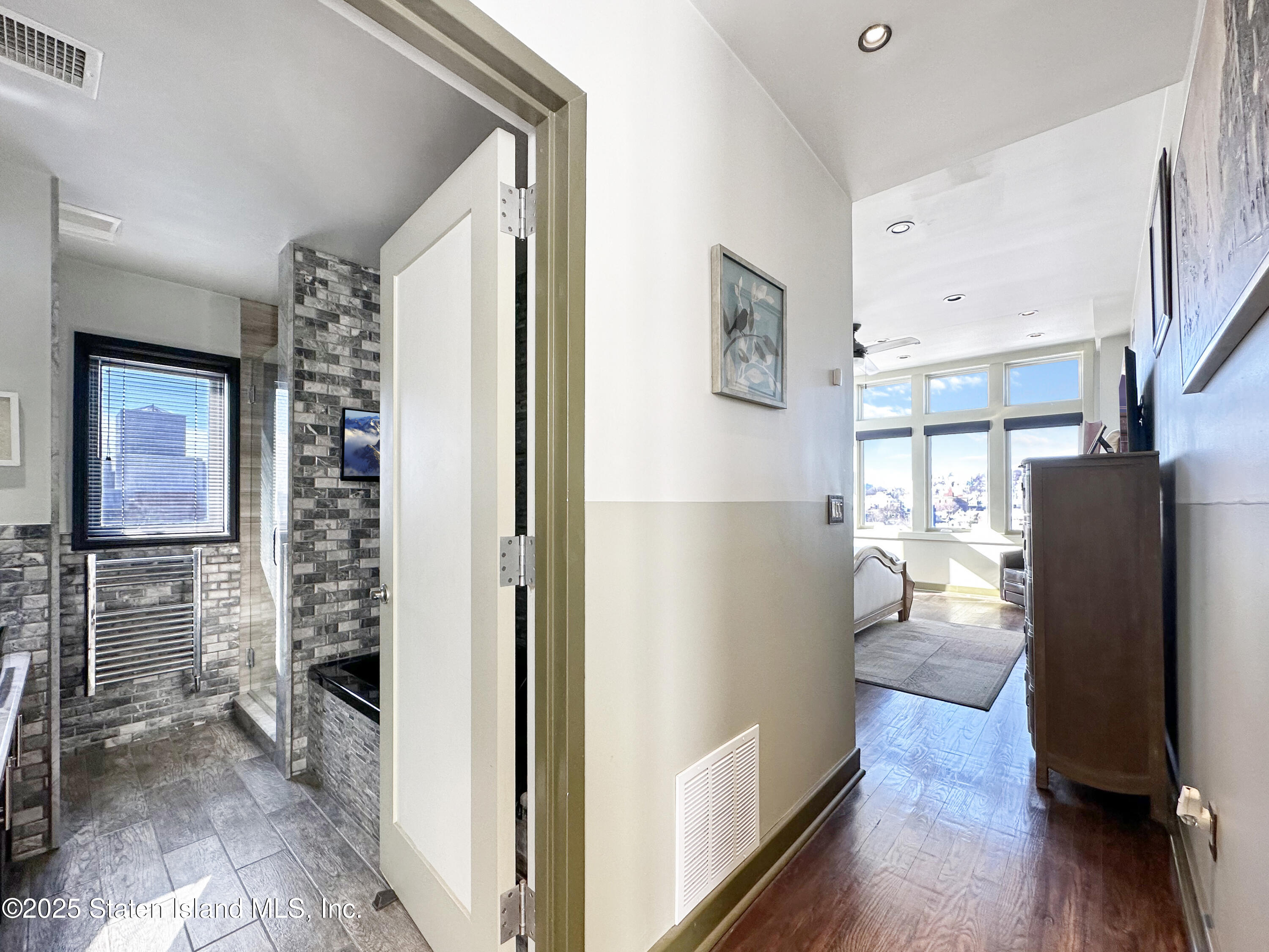 90 Bay Street Landing, Unit 9C Staten Island, NY 10301 - Photo 17 of 38 a view of a hallway with wooden floor and windows