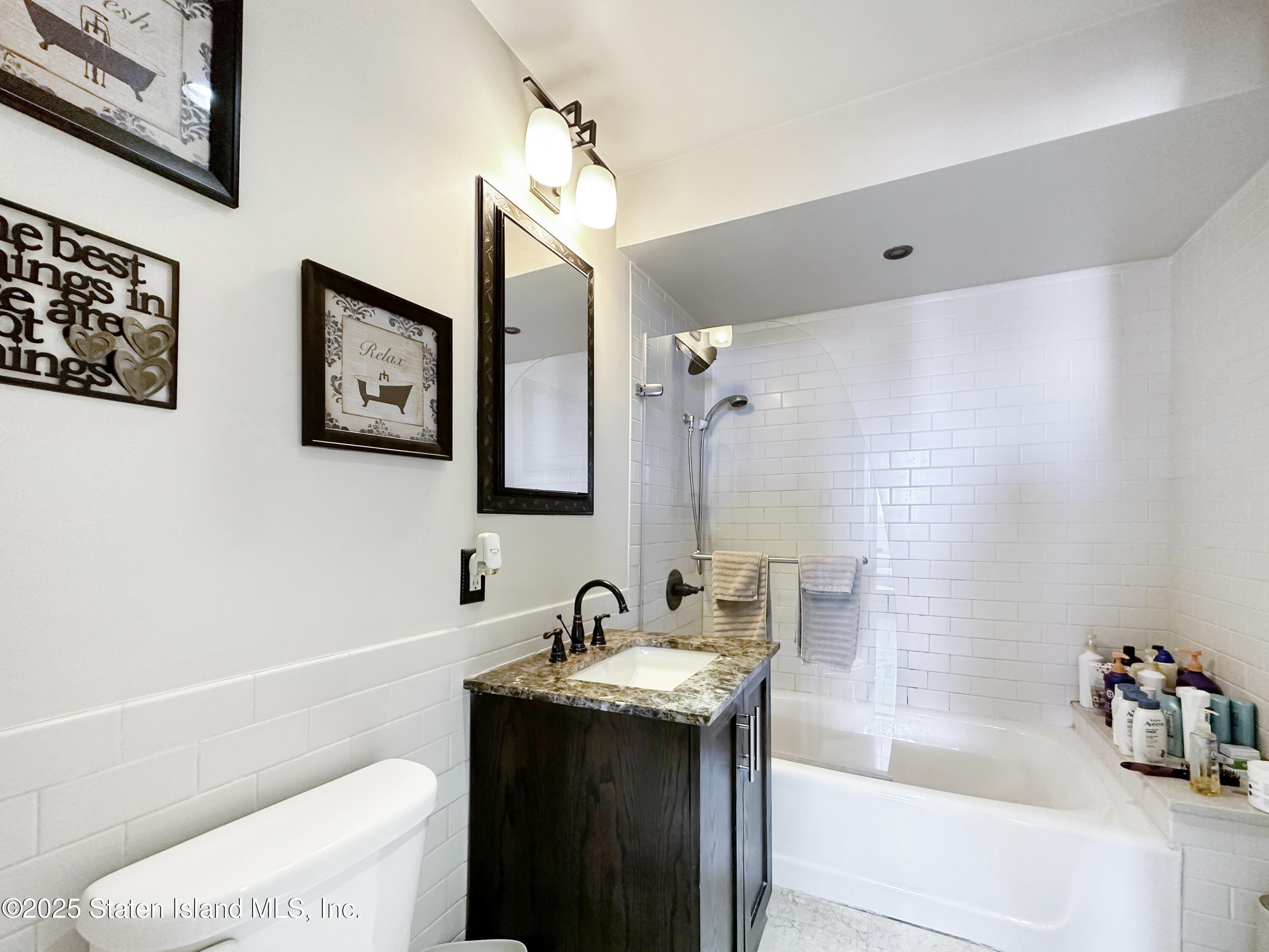90 Bay Street Landing, Unit 9C Staten Island, NY 10301 - Photo 26 of 38 a bathroom with a sink toilet and shower
