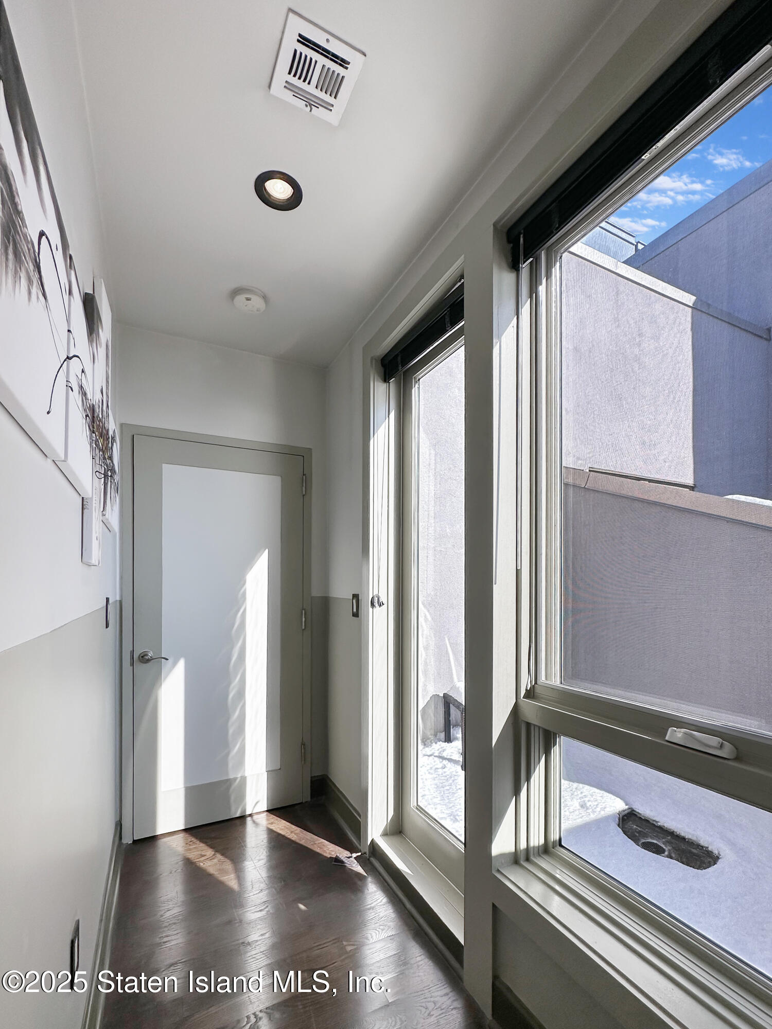90 Bay Street Landing, Unit 9C Staten Island, NY 10301 - Photo 31 of 38 a view of a hallway with a glass door and furniture