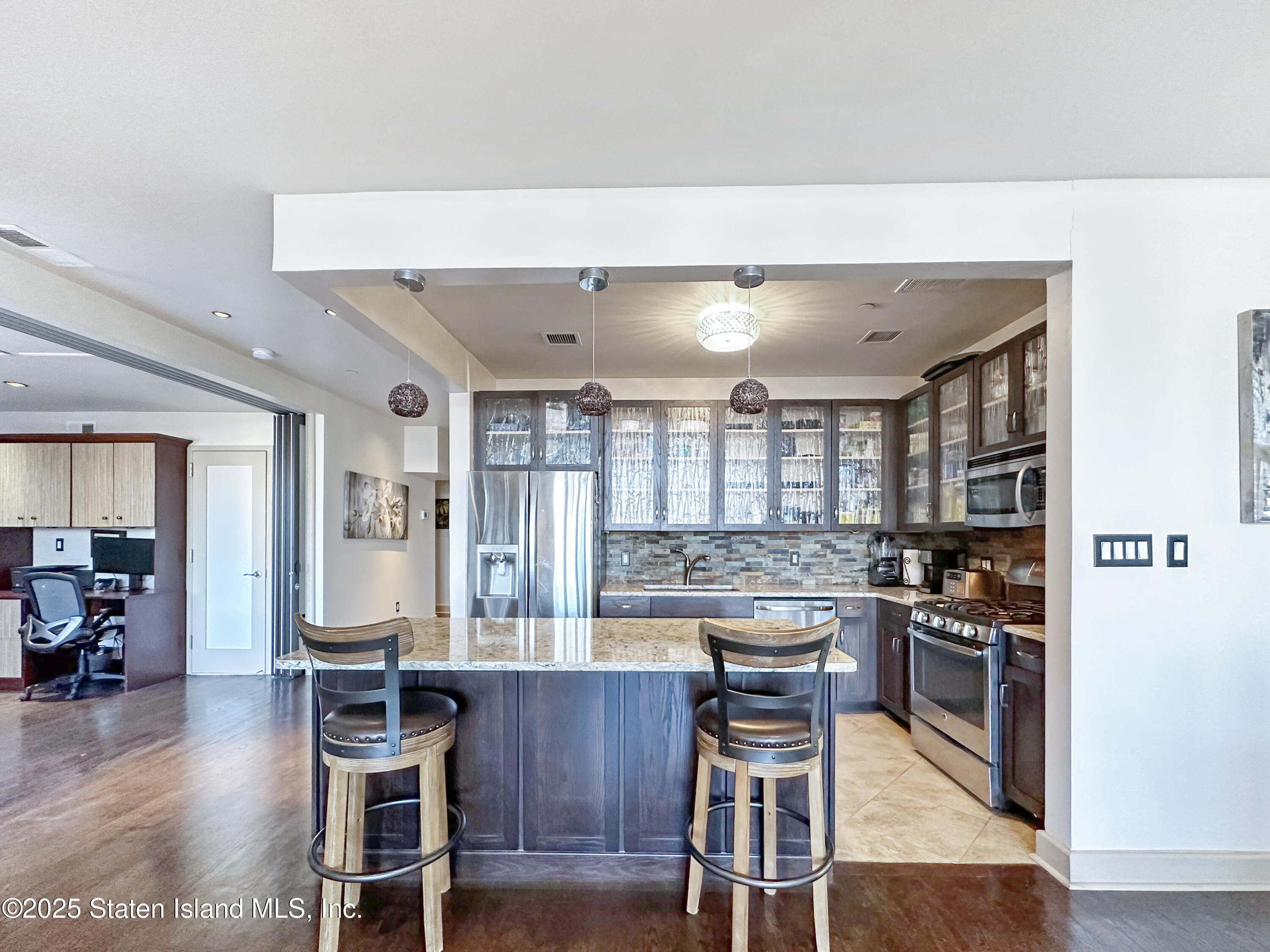 90 Bay Street Landing, Unit 9C Staten Island, NY 10301 - Photo 9 of 38 a kitchen with a table and chairs in it