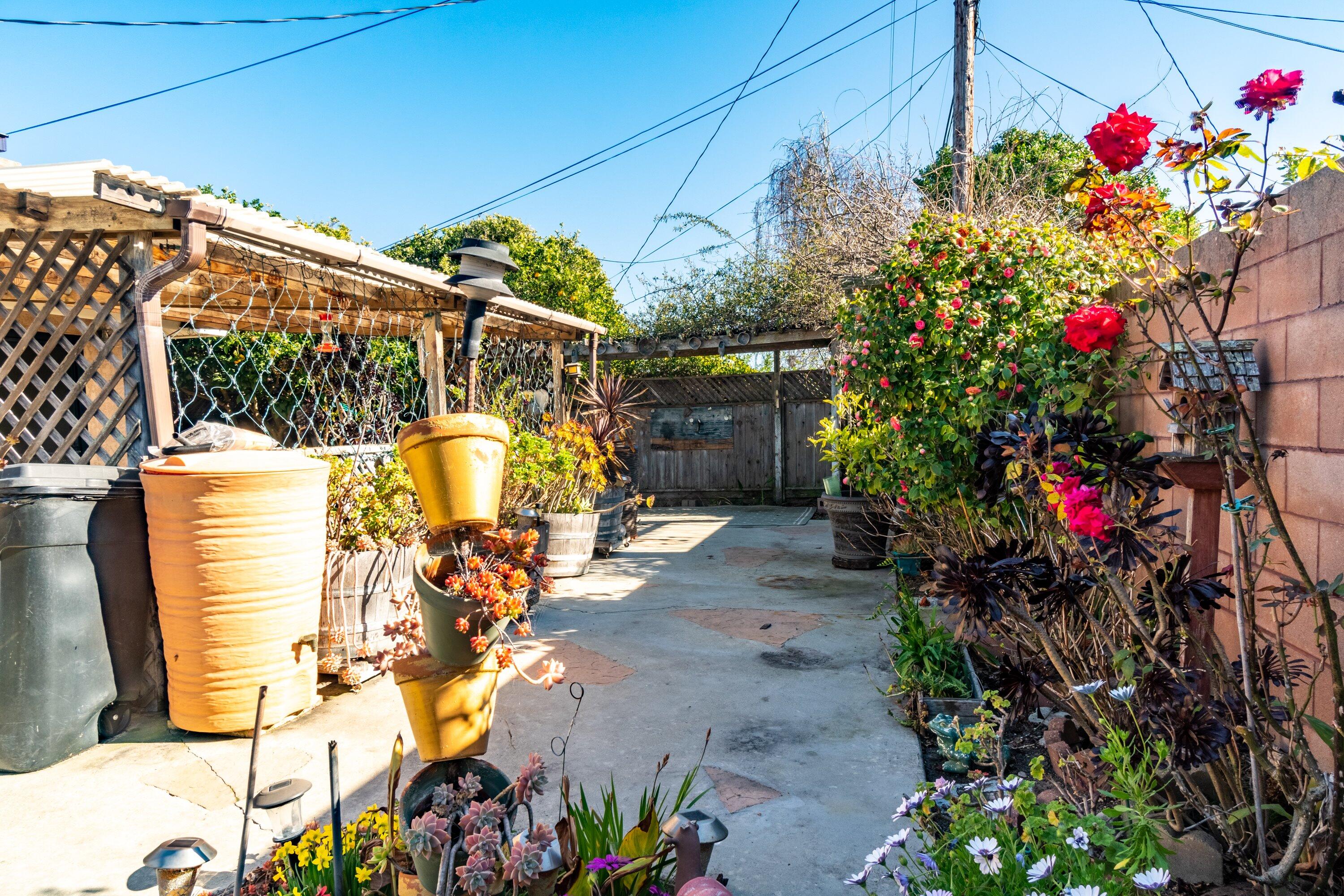 4076 Constellation Road Lompoc, CA 93436 - Photo 17 of 21 a vase of flowers sitting on a sidewalk