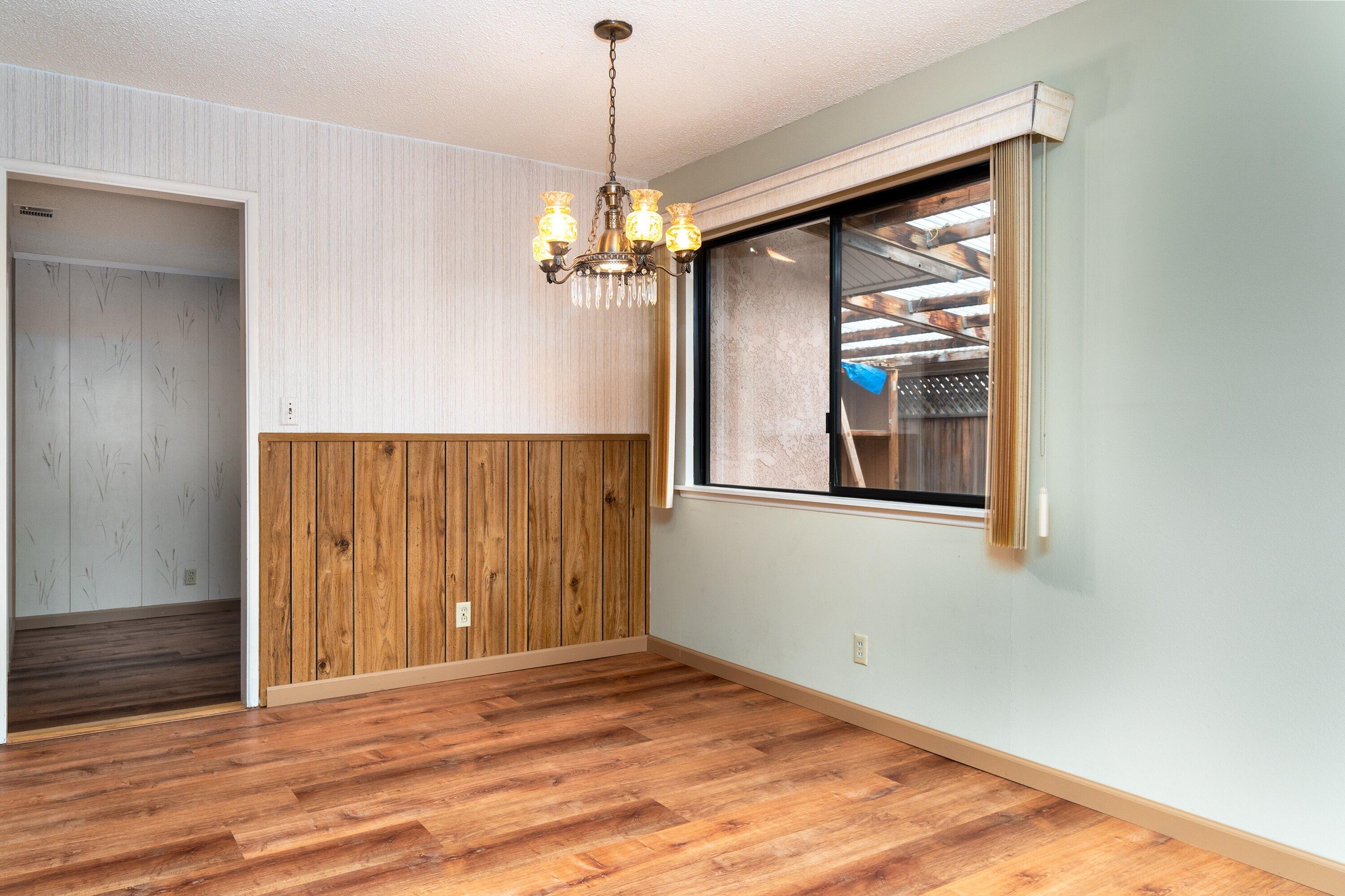 4076 Constellation Road Lompoc, CA 93436 - Photo 6 of 21 a view of an empty room with wooden floor and a window