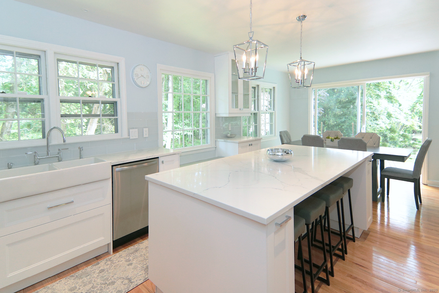 a open kitchen with stainless steel appliances granite countertop a sink a stove and chairs
