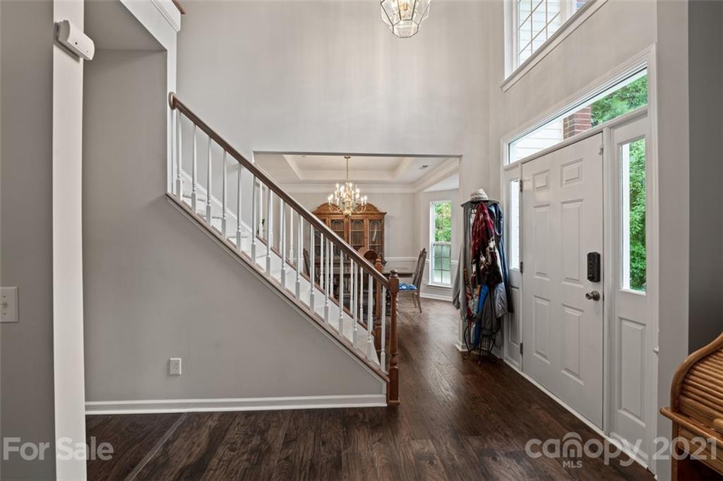 7414 Reedy Creek Road Charlotte, NC 28215 - Photo 3 of 34 a view of hallway with wooden floor and stairs