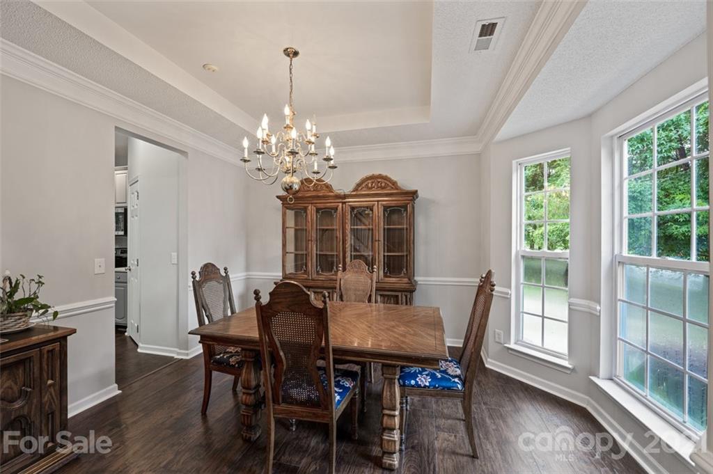 7414 Reedy Creek Road Charlotte, NC 28215 - Photo 4 of 34 a view of a dining room with furniture window and wooden floor