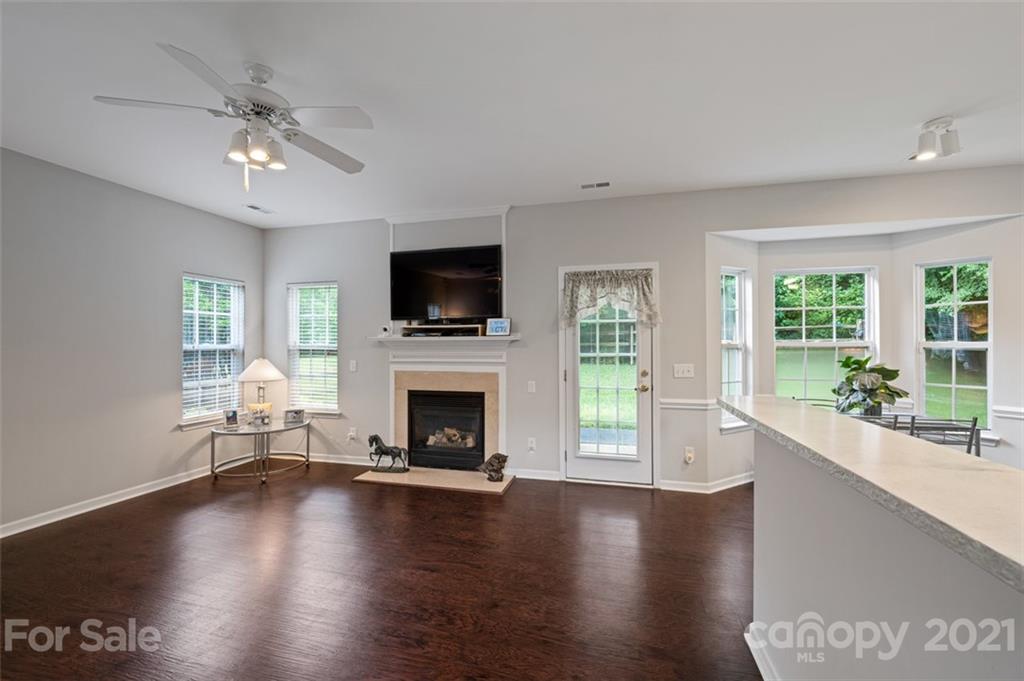 7414 Reedy Creek Road Charlotte, NC 28215 - Photo 8 of 34 a living room with fireplace furniture and a wooden floor