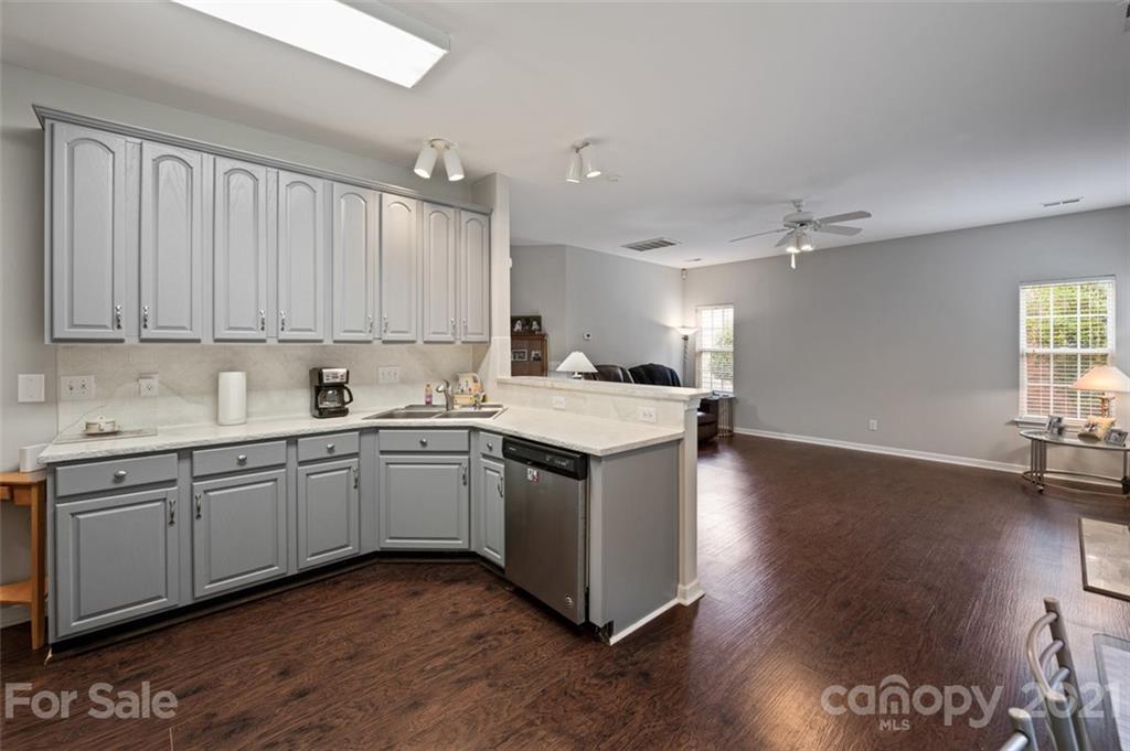 7414 Reedy Creek Road Charlotte, NC 28215 - Photo 10 of 34 a kitchen with stainless steel appliances granite countertop a sink and stove top oven