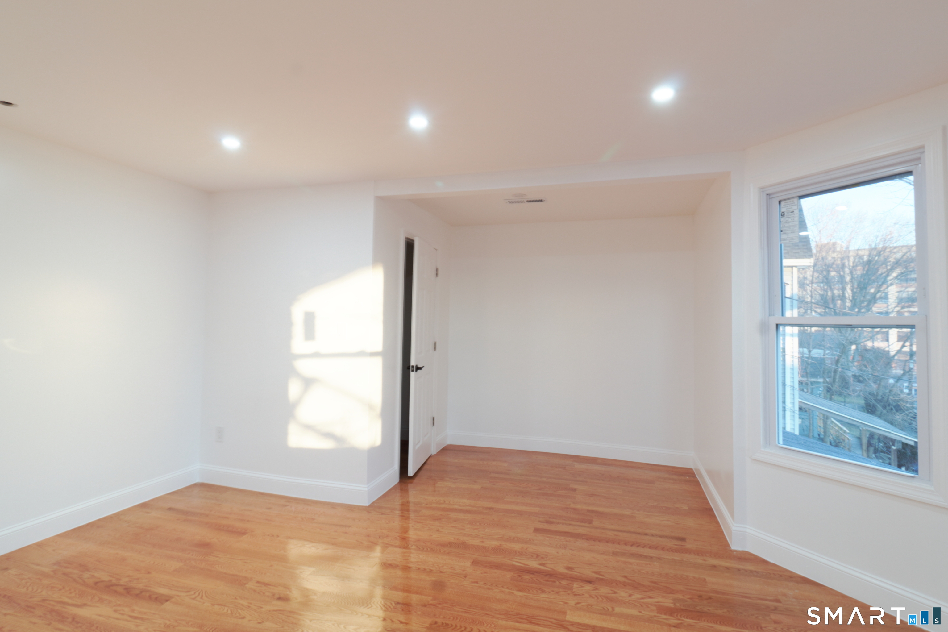 40 Elizabeth Street, Unit 2 Waterbury, CT 06704 - Photo 8 of 11 a view of empty room with wooden floor and fan