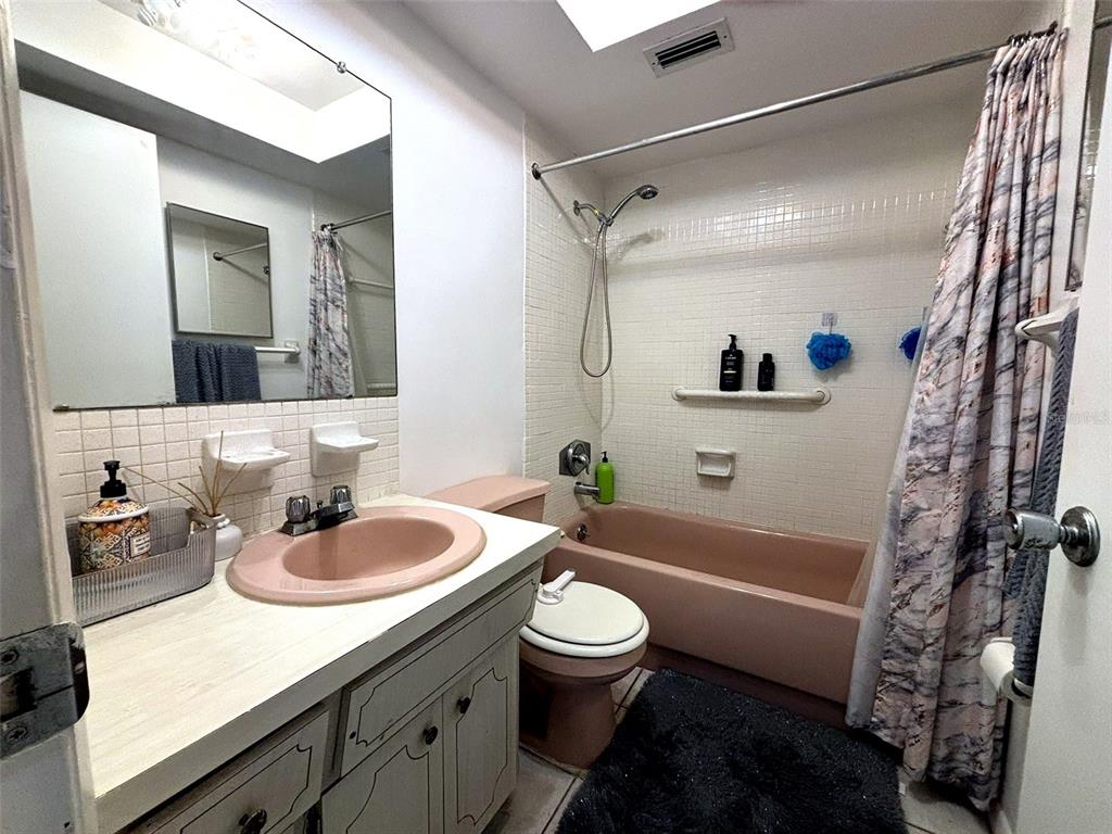 1433 South Belcher Road, Unit B2 Clearwater, FL 33764 - Photo 14 of 20 a bathroom with a sink a toilet and a mirror