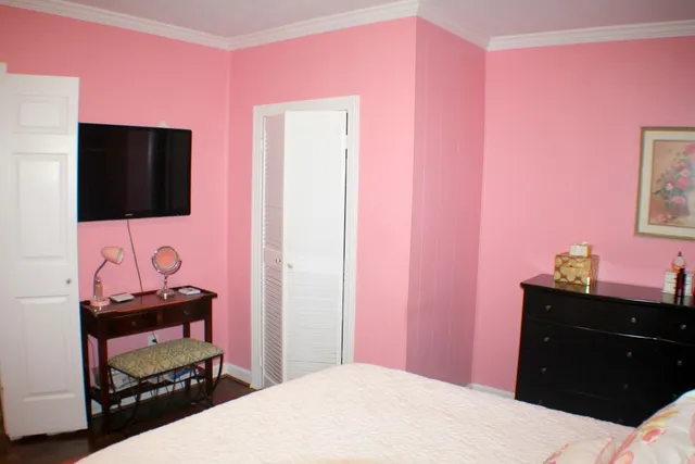 a bedroom with a bed and a flat screen tv