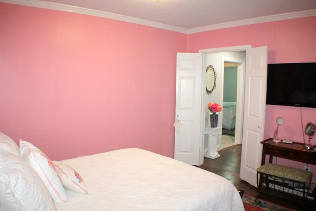 a bedroom with a bed and a flat screen tv