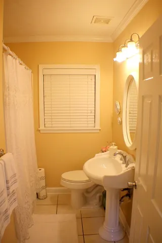 a bathroom with a sink toilet and mirror