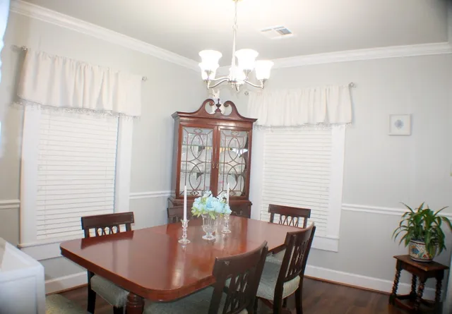 a view of a dining room with furniture and chandelier