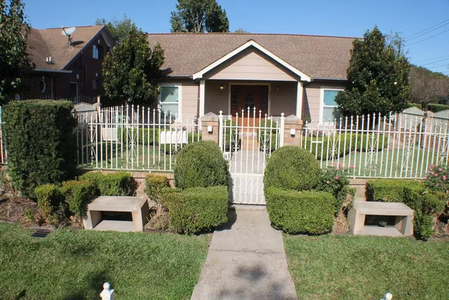 a front view of a house with a garden