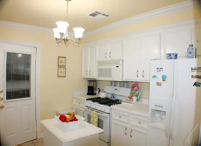 a kitchen with a sink a stove and refrigerator