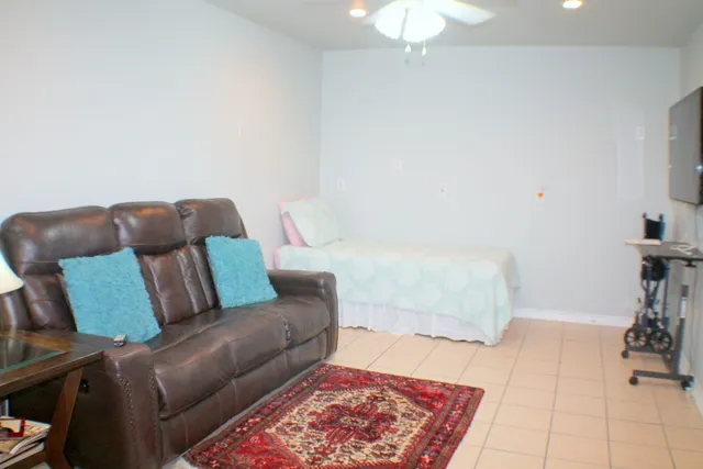 a living room with a couch and a chandelier