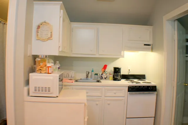 a kitchen with a sink and cabinets
