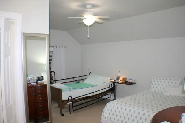 a bedroom with furniture and a chandelier