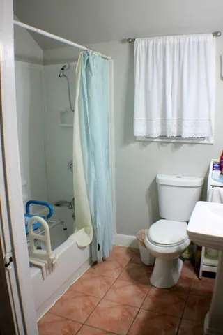 a bathroom with a sink toilet and shower