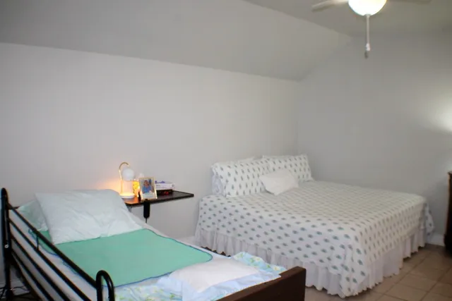 a bedroom with a bed and a chandelier