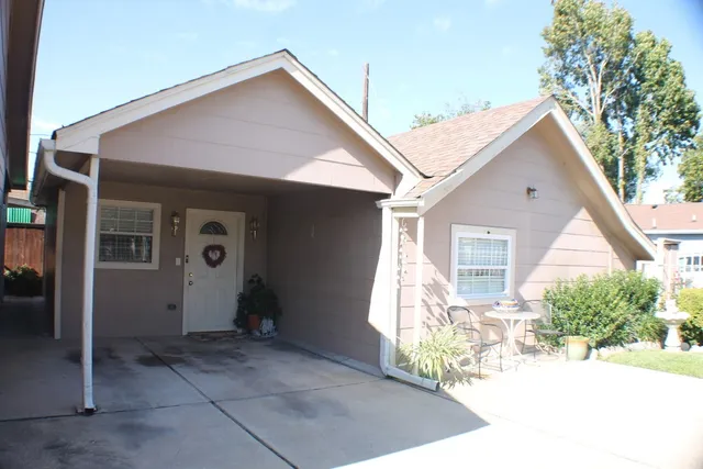 a backyard of a house with potted plants