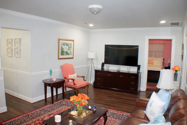 a living room with furniture and a flat screen tv